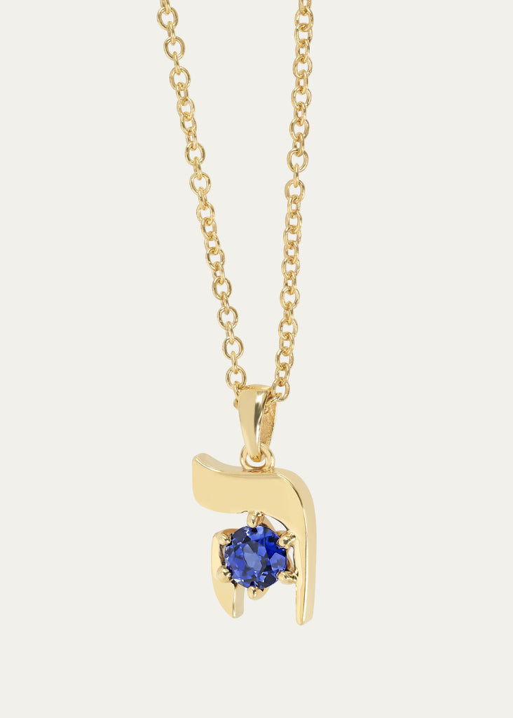Close-up of 18K yellow gold HEI pendant with blue sapphire and Rolo chain